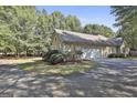 Another side view of house with garage and landscaping at 365 Pendleton Trl, Tyrone, GA 30290