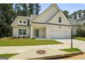 Two-story house with light beige siding, green door, and attached garage at 105 Wyonia Way, Fayetteville, GA 30215