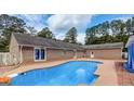 Brick home with a kidney-shaped swimming pool at 105 Creekwood Ln, Fayetteville, GA 30214