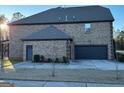 Brick home with a three-car garage and a large backyard at 2801 Karras Cv, Hampton, GA 30228