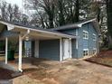 Front view of a blue house with carport at 2803 Norgate Ln, Decatur, GA 30034