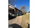 Side yard view of house with additional driveway space at 1839 Lakewood Se Ave, Atlanta, GA 30315