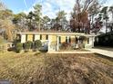Ranch home with gray exterior, boarded windows, and green lawn at 2252 Brannen Se Rd, Atlanta, GA 30316