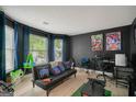 Cozy game room featuring a futon, gaming setup, and large windows at 4197 Arnolds Mill Opas, Douglasville, GA 30135