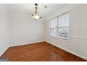 Formal dining room with hardwood floors and a large window at 305 Foster Trace Dr, Lawrenceville, GA 30043