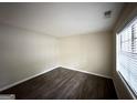 Spacious bedroom with dark laminate wood flooring and window blinds at 2749 Williamsburg Dr, Decatur, GA 30034