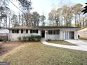 Brick ranch home with a covered porch and mature trees at 2749 Williamsburg Dr, Decatur, GA 30034