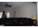 Living room with sectional sofa, Christmas tree, and ceiling fan at 732 Country Lake Drive Dr, Hampton, GA 30228