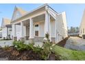 Side view of house showcasing landscaping and porch at 613 Cork St, Woodstock, GA 30188