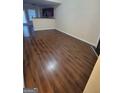 Spacious living room featuring dark brown vinyl flooring at 3068 Broadleaf Trl, Fairburn, GA 30213