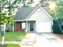 Charming one-story home with a brick facade and attached garage at 261 Coral Cir, Mcdonough, GA 30253