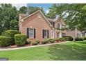 Brick home with a neatly landscaped yard at 4543 Red Tail Dr, Lithonia, GA 30038