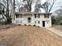 Newly painted brick house with a green door and attached garage at 4436 Malibu Dr, Decatur, GA 30035