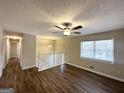 Spacious living room with hardwood floors, a ceiling fan, and large windows at 4436 Malibu Dr, Decatur, GA 30035