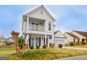 Two-story house with balcony, attached garage, and landscaping at 306 Turtle Pointe Dr, Carrollton, GA 30116