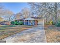 Front view of brick ranch home with driveway and carport at 707 Battlecreek Rd, Jonesboro, GA 30236