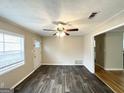 Spacious living area with hardwood floors, neutral walls and ceiling fan at 10178 Allen Sw Dr, Covington, GA 30014