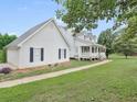 White house with a detached garage and walkway at 2110 Mcgarity Rd, Mcdonough, GA 30252