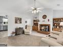 Spacious living room featuring a brick fireplace and neutral decor at 220 Melrose Way, Mcdonough, GA 30252