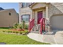 Brick house with red door and landscaping at 633 Mill Creek Trl, Jonesboro, GA 30238