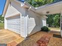 White garage with separate storage area and brick pathway at 1293 Coan Dr, Locust Grove, GA 30248