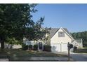 House exterior showcasing landscaping and a two-car garage at 30 Capeton Ct, Covington, GA 30016
