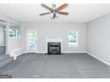 Spacious living room featuring a fireplace and grey carpeting at 30 Capeton Ct, Covington, GA 30016