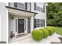 Inviting front entrance with a black door, wreath, and welcome sign at 427 Blackbird Way, Hampton, GA 30228