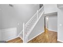 Bright entryway with hardwood floors and a staircase with white railing at 427 Blackbird Way, Hampton, GA 30228