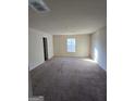 Large bedroom with carpeted floors and a window with blinds at 552 Moline Way, Locust Grove, GA 30248