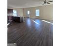 Open concept kitchen with island and dark brown cabinets at 552 Moline Way, Locust Grove, GA 30248