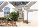 Front entrance with stone accents and a wreath at 302 Preston Chase Dr, Peachtree City, GA 30269