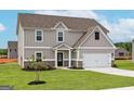 Two-story house with gray siding, white trim, and a two-car garage at 576 Moline Way, Locust Grove, GA 30248