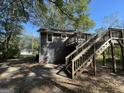 Back exterior of house with wooden deck and stairs leading to the ground at 361 Almon Rd, Covington, GA 30014