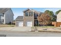 Two-story brick home with attached two-car garage at 11075 Shadow Ct, Hampton, GA 30228