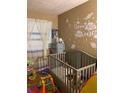 Bedroom featuring crib, toys, and space-themed decor at 3806 London Dr, Decatur, GA 30032