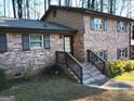 Brick house with covered entry and landscaping at 4520 Clement Sw Dr, Atlanta, GA 30331