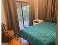 Bright bedroom with a queen-size bed and access to a screened porch at 1193 Clifton Rd, Atlanta, GA 30307
