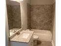 Clean bathroom with granite countertop, bathtub, and tile shower at 2120 Railyard Avenue # 13, Grayson, GA 30017
