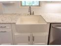 Modern farmhouse kitchen sink with white cabinetry and quartz countertops at 2120 Railyard Avenue # 13, Grayson, GA 30017