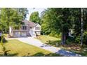 Two-story house with a three-car garage and a spacious driveway at 6277 N Sweetwater Rd, Lithia Springs, GA 30122