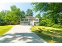 Two-story house with a two-car garage and a landscaped yard at 6277 N Sweetwater Rd, Lithia Springs, GA 30122