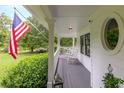 Spacious front porch with rocking chairs and American flag at 2398 Maddox Rd, Buford, GA 30519