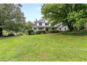 Two-story white house with a large green lawn at 2398 Maddox Rd, Buford, GA 30519