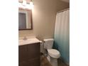 Clean bathroom with a white toilet and teal shower curtain at 650 Lowell Sw Dr, Marietta, GA 30008