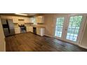 Modern kitchen featuring stainless steel appliances and wood-look flooring at 6050 April Dr, Sugar Hill, GA 30518