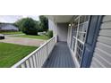 Inviting front porch with a gray deck and white railings at 6050 April Dr, Sugar Hill, GA 30518