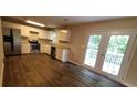 Modern kitchen featuring stainless steel appliances and wood-look flooring at 6050 April Dr, Sugar Hill, GA 30518