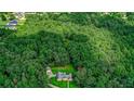 House nestled in a large wooded lot, seen from above at 3409 Camp Branch Rd, Buford, GA 30519