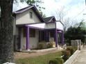 Charming two-story home with purple accents and landscaped yard at 916 Metropolitan Sw Pkwy, Atlanta, GA 30310